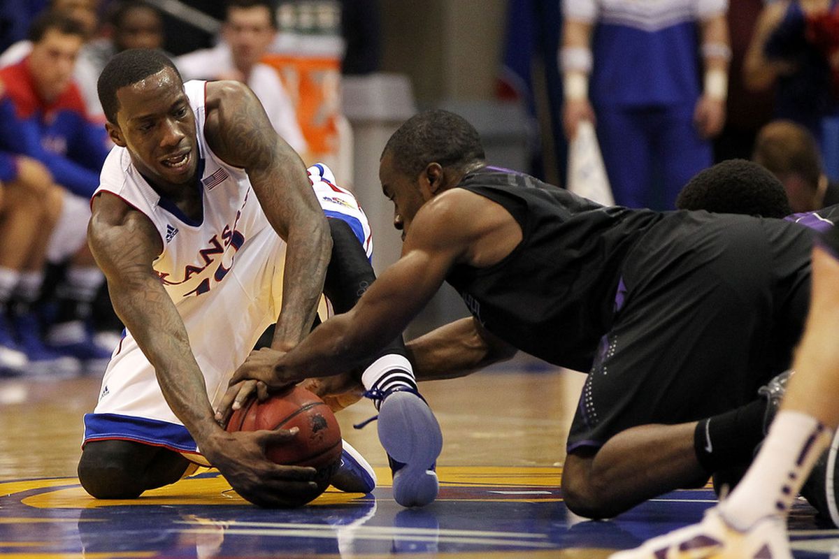 LAWRENCE, KS - JANUARY 04:  Tyshawn Taylor #10 of the Kansas Jayhawks battles Martavious Irving #3  of the Kansas State Wildcats during the game on January 4, 2012 at Allen Fieldhouse in Lawrence, Kansas.  (Photo by Jamie Squire/Getty Images)