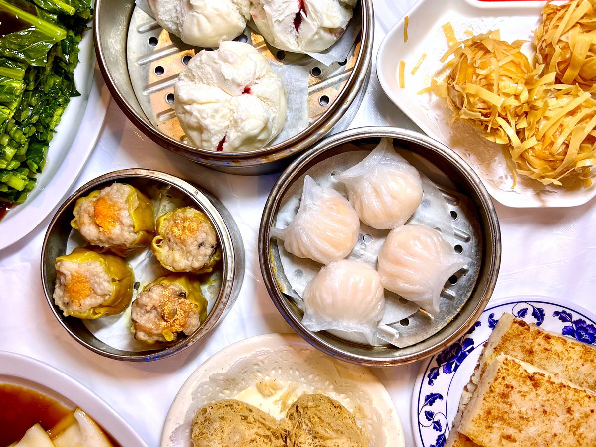 steamer tins of steamed bao buns, shu mai, har gow, and a plate of crispy shrimp balls at Dim Sum King.