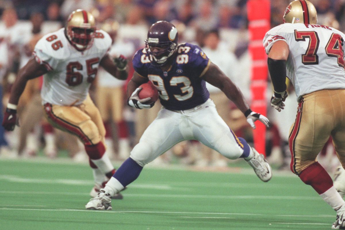 Minneapolis Mn , Vikings vs San Francisco 10/24/99—Vikings defensive tackle John Randle tries to avoid San Francisco√≠s Ray Brown (65), Dave Fiore after Randle intercepted a pass thrown by Jeff Garcia during the 2nd quarter. The interception was his
