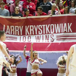 Utah fans hold up a banner celebrating Utah head coach Larry Krystkowiak's 100th win during an NCAA college basketball game against Montana State at the Huntsman Center in Salt Lake City on Thursday, Dec. 1, 2016. Utah defeated Montana State 92-84.
