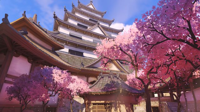 The exterior of Shimada castle is flanked by cherry blossom trees in a screenshot of Overwatch’s Hanamura map