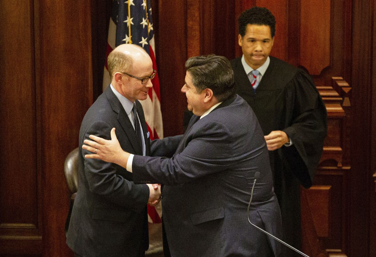 Gov. J.B. Pritzker congratulates Democrat Don Harmon, D-Oak Park, just before Harmon took the oath of office to become state Senate president last year.