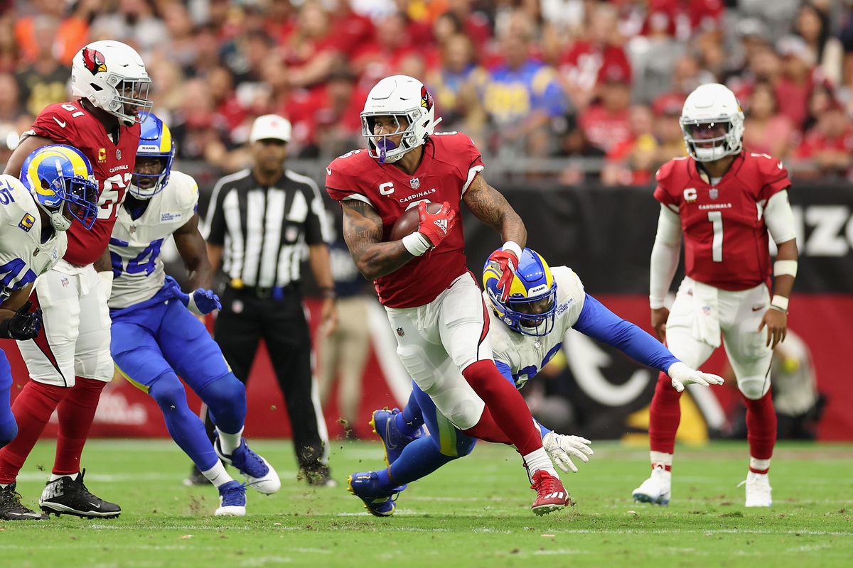 Running back James Conner #6 of the Arizona Cardinals rushes the football against the Los Angeles Rams during the first half of the NFL game at State Farm Stadium on September 25, 2022 in Glendale, Arizona.