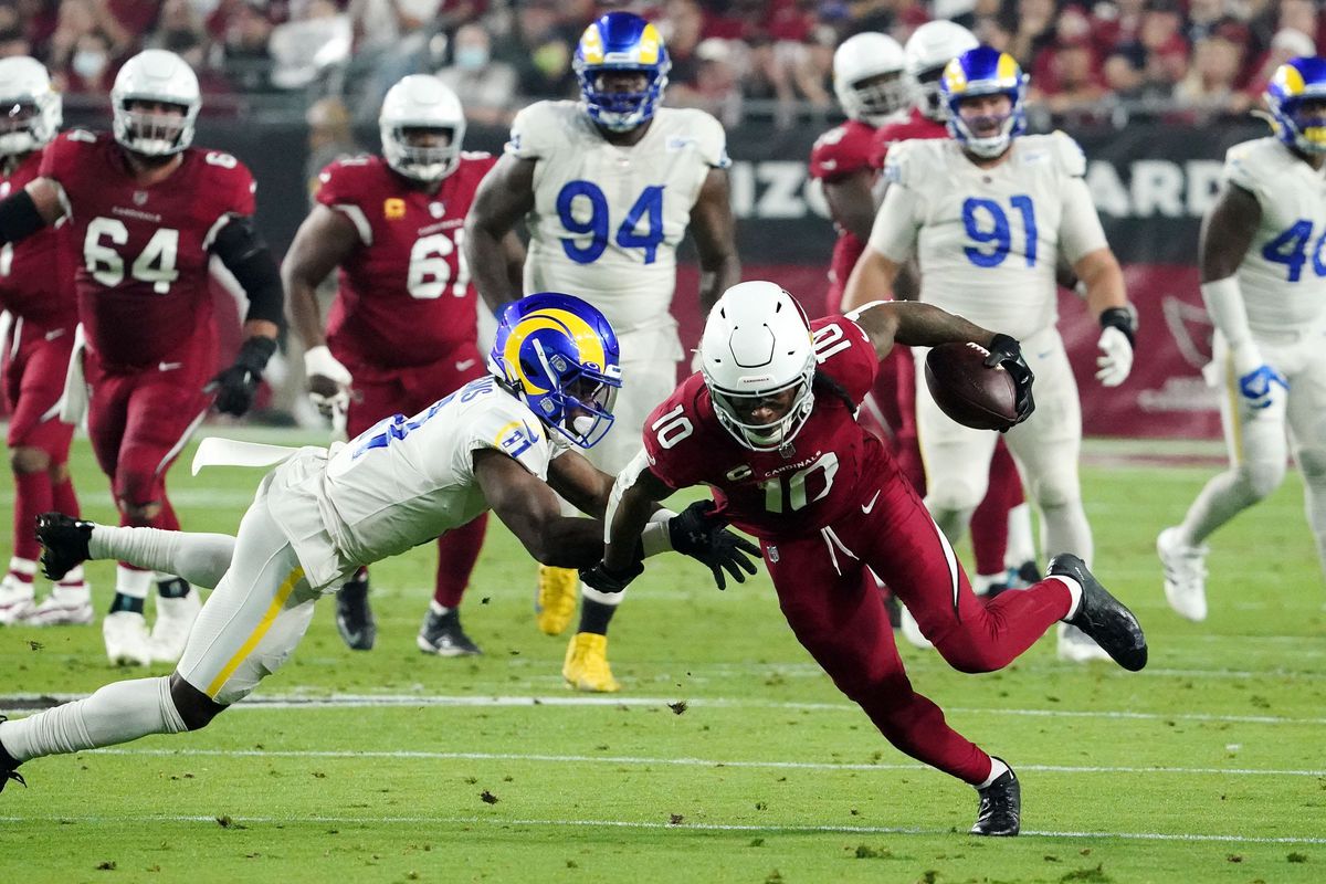 Arizona Cardinals wide receiver DeAndre Hopkins (10) is tackled by Los Angeles Rams cornerback Darious Williams (11) at State Farm Stadium.