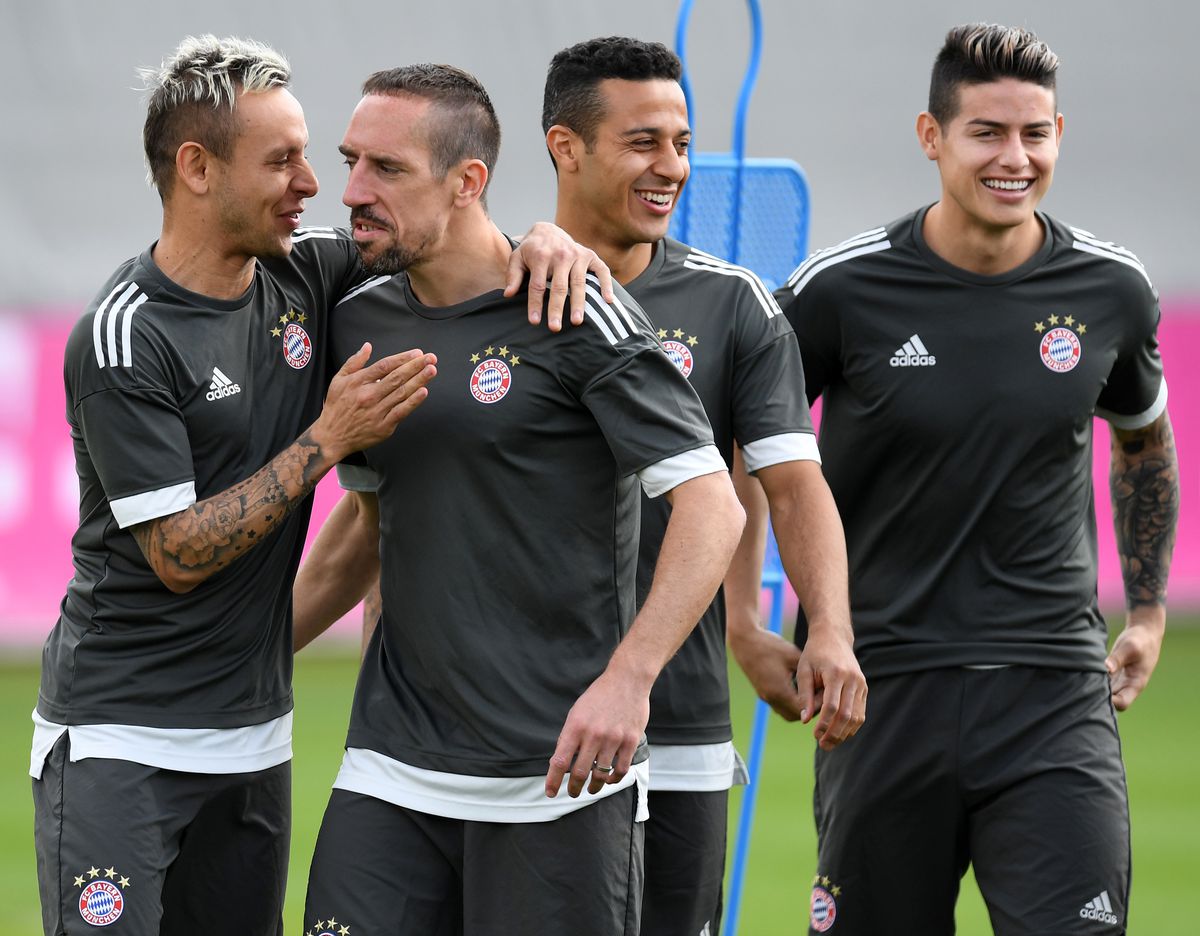 Bayern Munich's Brazilian defender Rafinha, French midfielder Franck Ribery, Spanish midfilder Thiago and Colombian midfielder James Rodriguez joke during a training session at the trainings ground of FC Bayern Munich in Munich, southern Germany, on April 24, 2018 on the eve of the UEFA Champions League first leg semi-final football match between Bayern Munich and Real Madrid.