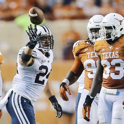 BYU's Algernon Brown tosses the ball to a ref after his run as BYU and Texas play Saturday, Sept. 6, 2014, in Austin Texas.