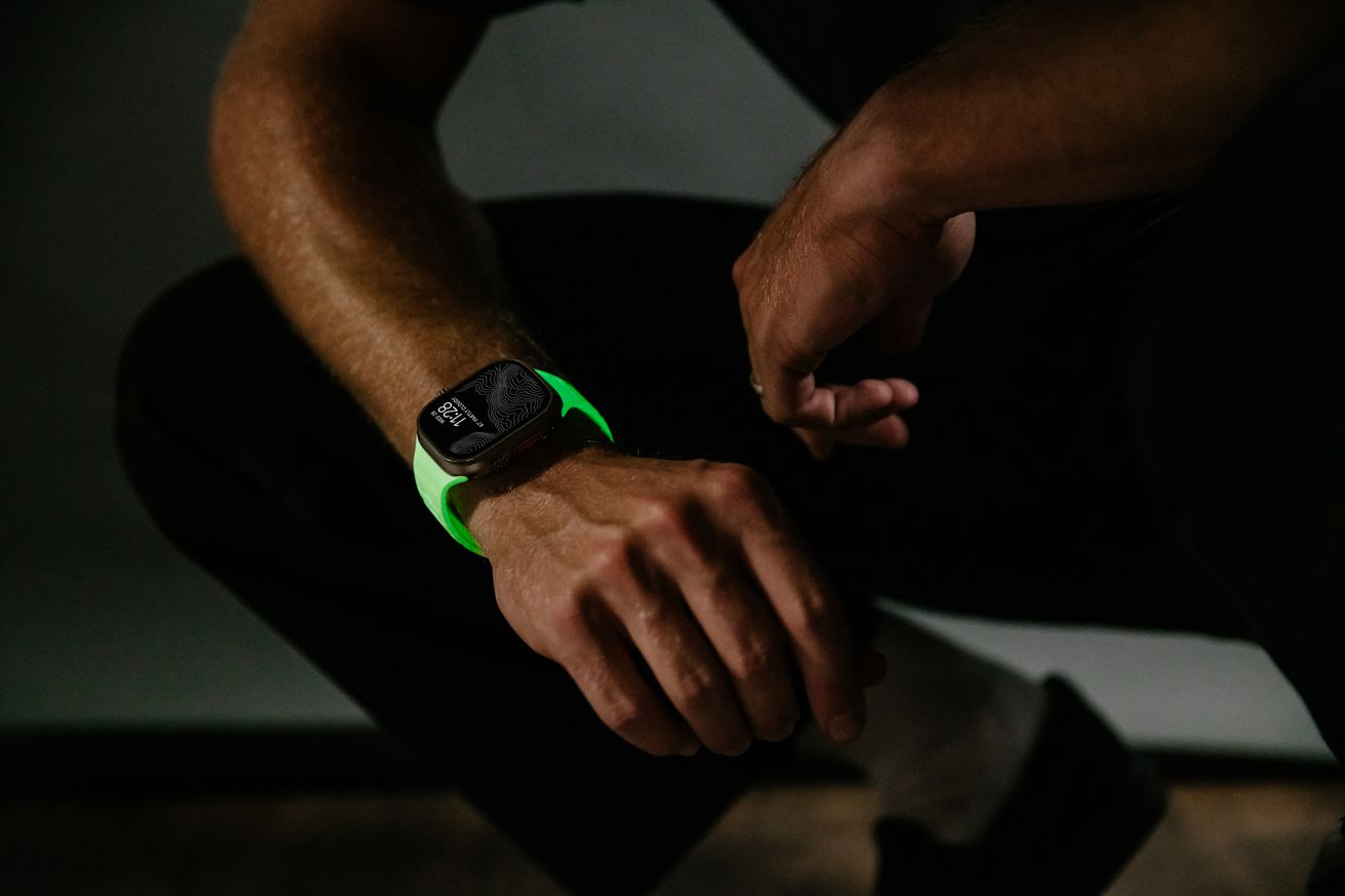 Person wearing Nomad’s glow in the dark Apple Watch strap