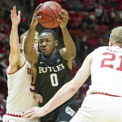 Butler guard Avery Woodson (0) drives past Utah guard Parker Van Dyke (5) and forward Tyler Rawson (21) during an NCAA college basketball game at the Huntsman Center in Salt Lake City on Monday, Nov. 28, 2016. Butler took down Utah 68-59 to remain undefeated.