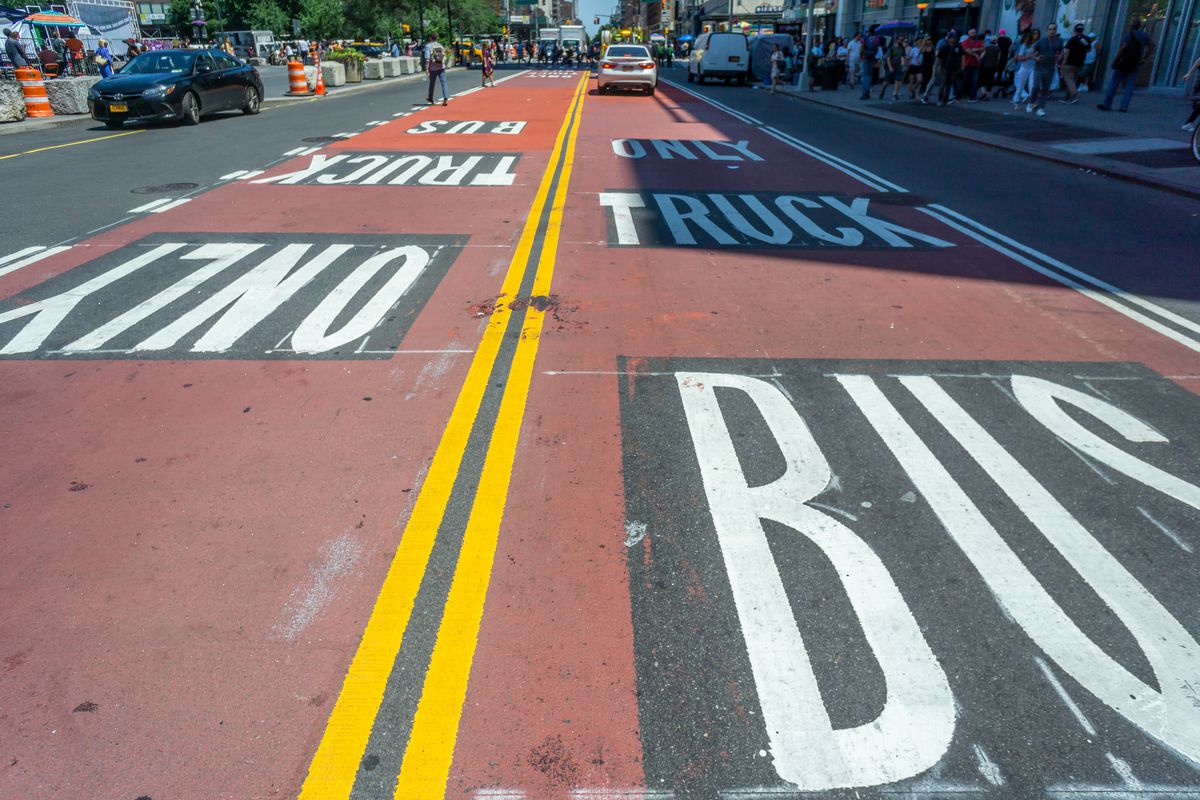 A New York City street marked up with red bus lanes.