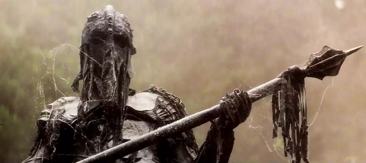 A ghoulish zombie in black armor covered in cobwebs wields a large spear in Black Angel.