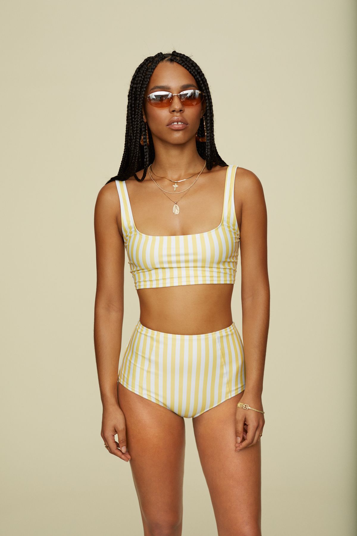 A model wearing a white and yellow striped bikini