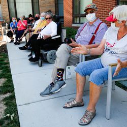 Residents of Sagewood at Daybreak, a senior living community in South Jordan, wear masks while watching a courtyard concert featuring Nathan Osmond on Friday, July 17, 2020.