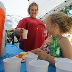 Kaylie Nash and mother Nikita Casner pick out a drink as Subway serves a free lunch to nearly 1,100 needy people at Pioneer Park in Salt Lake City on Wednesday, June 5, 2013. Local Subway restaurants and the Rescue Mission of Salt Lake teamed up to raise awareness of the problems facing Salt Lake’s homeless and low-income families.