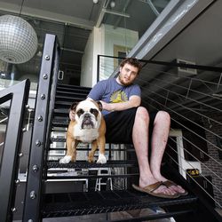 George Thaut spends time with his dog Sally in his home at Broadway Park Lofts in Salt Lake City, Thursday, July 10, 2014.