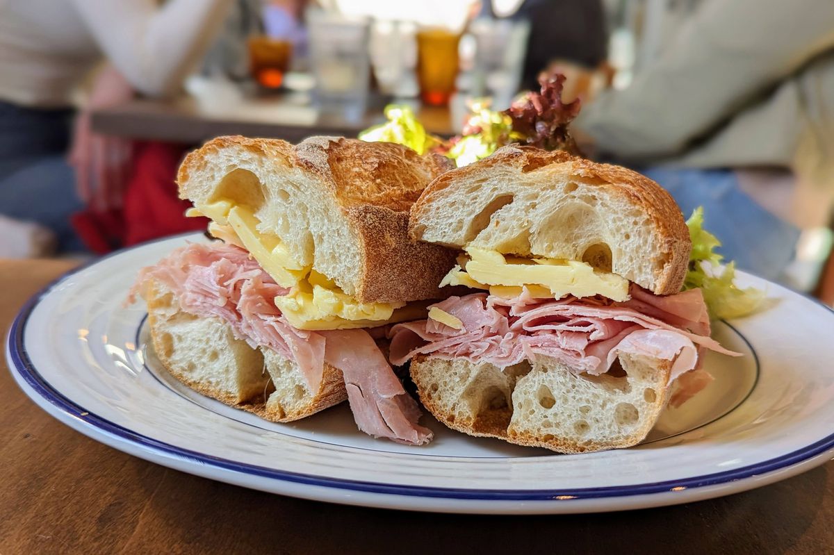 A ham and butter sandwich on a plate.