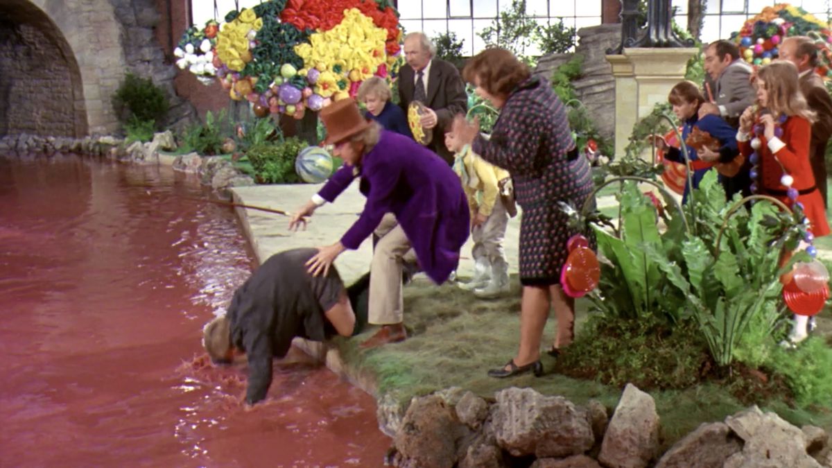 Augustus Gloop falls into the chocolate river in Willy Wonka and the Chocolate Factory.