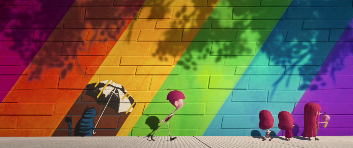 the children marching against a rainbow colored wall, tim lagging behind 