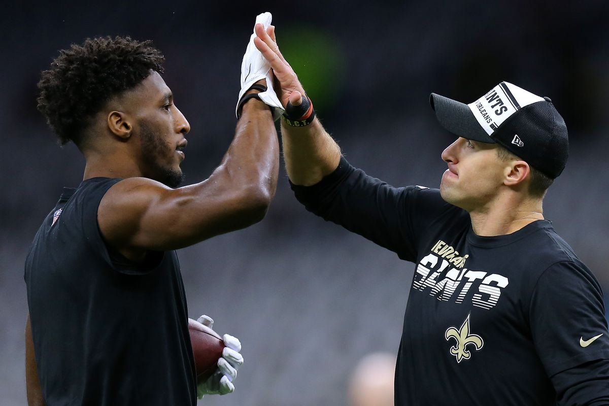 Drew Brees of the New Orleans Saints and Michael Thomas react during a game against the Carolina Panthers at the Mercedes Benz Superdome on November 24, 2019 in New Orleans, Louisiana.