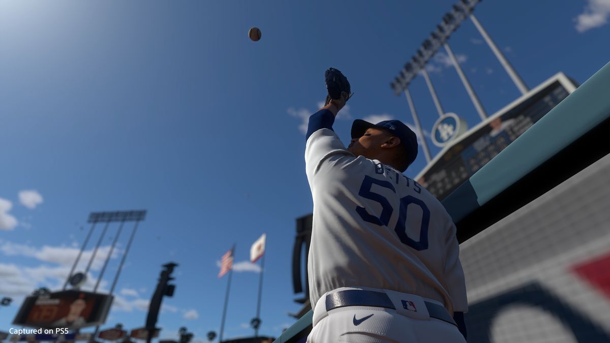 Dodger Mookie Betts jumps at the Dodger Stadium warning track for a fly ball in MLB The Show 21