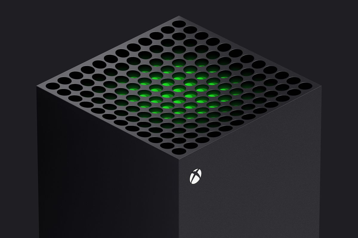 a three-quarters view of the top of the Xbox Series X, with a green piece of plastic visible just beneath the system vents