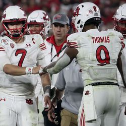 Utah Utes quarterback Cameron Rising fist-bumps Tavion Thomas as he leaves the field after getting injured in the game against Ohio State in the 108th Rose Bowl game in Pasadena, Calif., on Saturday, Jan. 1, 2022.