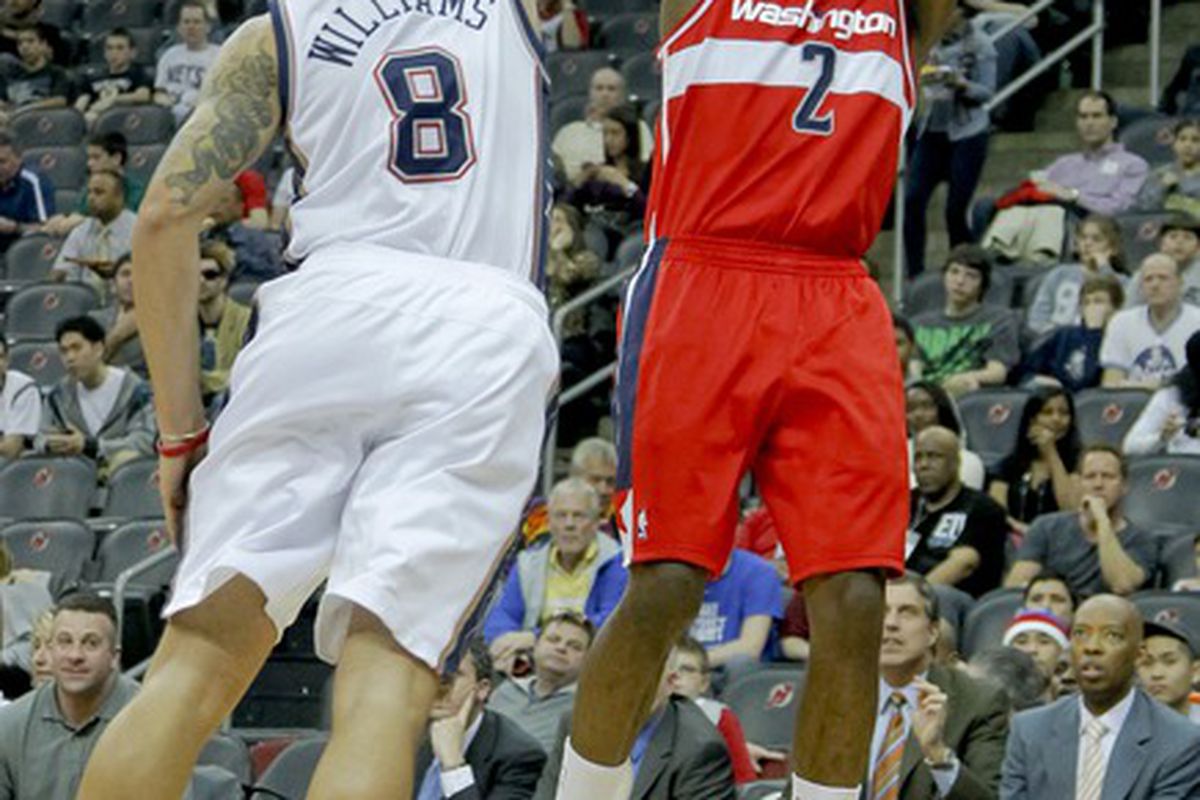 Mar 21, 2012; Newark, NJ, USA;  Washington Wizards point guard John Wall (2) shoots as New Jersey Nets point guard Deron Williams (8) defends at the Prudential Center. Mandatory Credit: Jim O'Connor-US PRESSWIRE