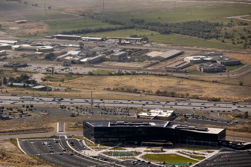 The Utah State Prison, top, and headquarters of tech company Pluralsight, bottom right, in Draper are pictured on Wednesday, Aug. 25, 2021. Once the prison relocates to its new site near the airport, the land will be redeveloped into The Point — a master planned “complete community.”