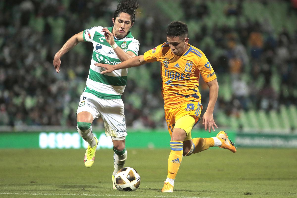 Leonardo Fernandez of Tigres (R) fights for the ball with Alan Cervantes of Santos during the quarterfinals first leg match between Santos Laguna and Tigres UANL as part of the Torneo Grita Mexico A21 Liga MX at Corona Stadium on November 25, 2021 in Torreon, Mexico.