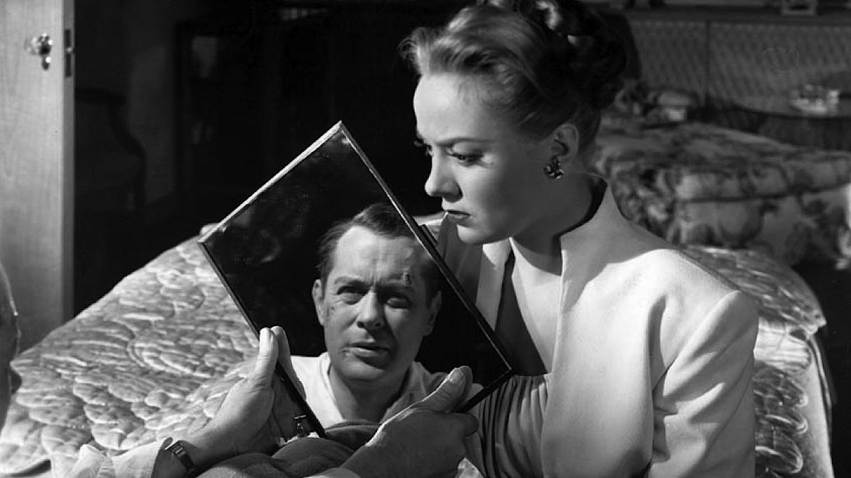 Robert Montgomery held in a mirror by Audrey Totter in Lady in the Lake