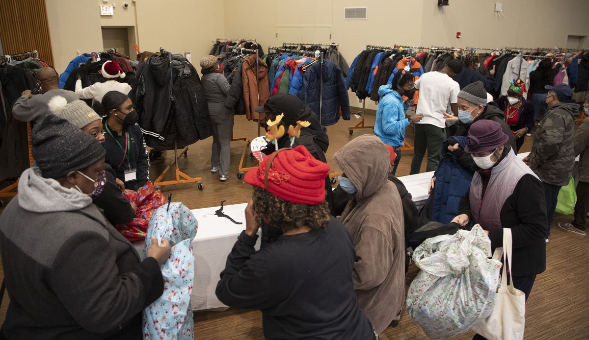 People shop among the free coats being offered inside Apostolic Faith Church in Bronzeville on Thursday, Dec. 23, 2021. It’s the 30th year of the giveaway; the coats — along with winter hats and gloves — are paid for by church members.