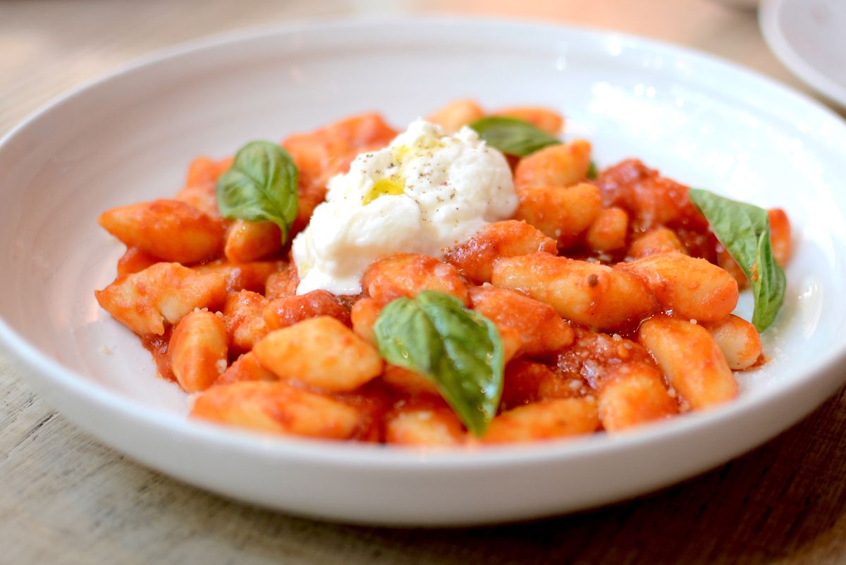 A plate of gnocchi in tomato sauce with basil and burrata at Sixth and Mill in the Arts District.