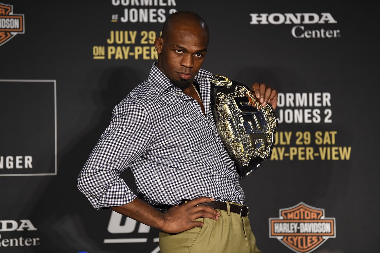 Jon Jones poses with the heavyweight title after knocking out Daniel Cormier at UFC 214.