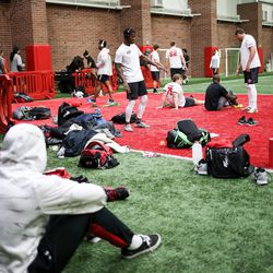 Players warm up and hang out on the sidelines at the University of Utah football pro day in Salt Lake City on Thursday, March 23, 2017.