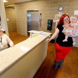 Elisha York, a monitor at the Road Home’s new Midvale Center, an emergency homeless shelter for families, talks with Jerika Johnson and her daughter, Rose Hansen, on Wednesday, March 9, 2016.