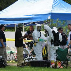 In this May 31, 2013 file photo, members of an FBI hazardous materials team prepare to enter a residence in New Boston, Texas in connection with a federal investigation surrounding ricin-laced letters mailed to President Barack Obama and New York Mayor Michael Bloomberg. Two U.S. law enforcement officials say Shannon Richardson of New Boston, Texas, has been arrested Friday, June 7, in the investigation.
