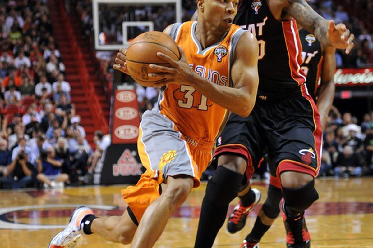 March 20, 2012; Miami, FL, USA; Phoenix Suns point guard Sebastian Telfair (31) drives to the basket past Miami Heat power forward Udonis Haslem (40) during the first half at American Airlines Arena. Mandatory Credit: Steve Mitchell-US PRESSWIRE