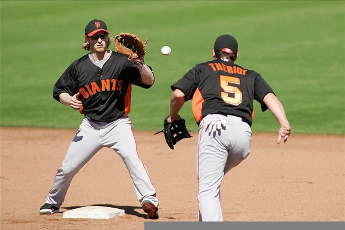 The Cajun Connection, reunited: San Francisco Giants second baseman Mike Fontenot catches a toss from shortstop Ryan Theriot during a fielding drill during spring training at Scottsdale Stadium. Credit: Jake Roth-US PRESSWIRE