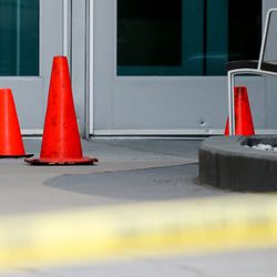 Police tape and orange cones are seen at one of the entrances to Fashion Place Mall in Murray after a shooting there on Sunday, Jan. 13, 2019.