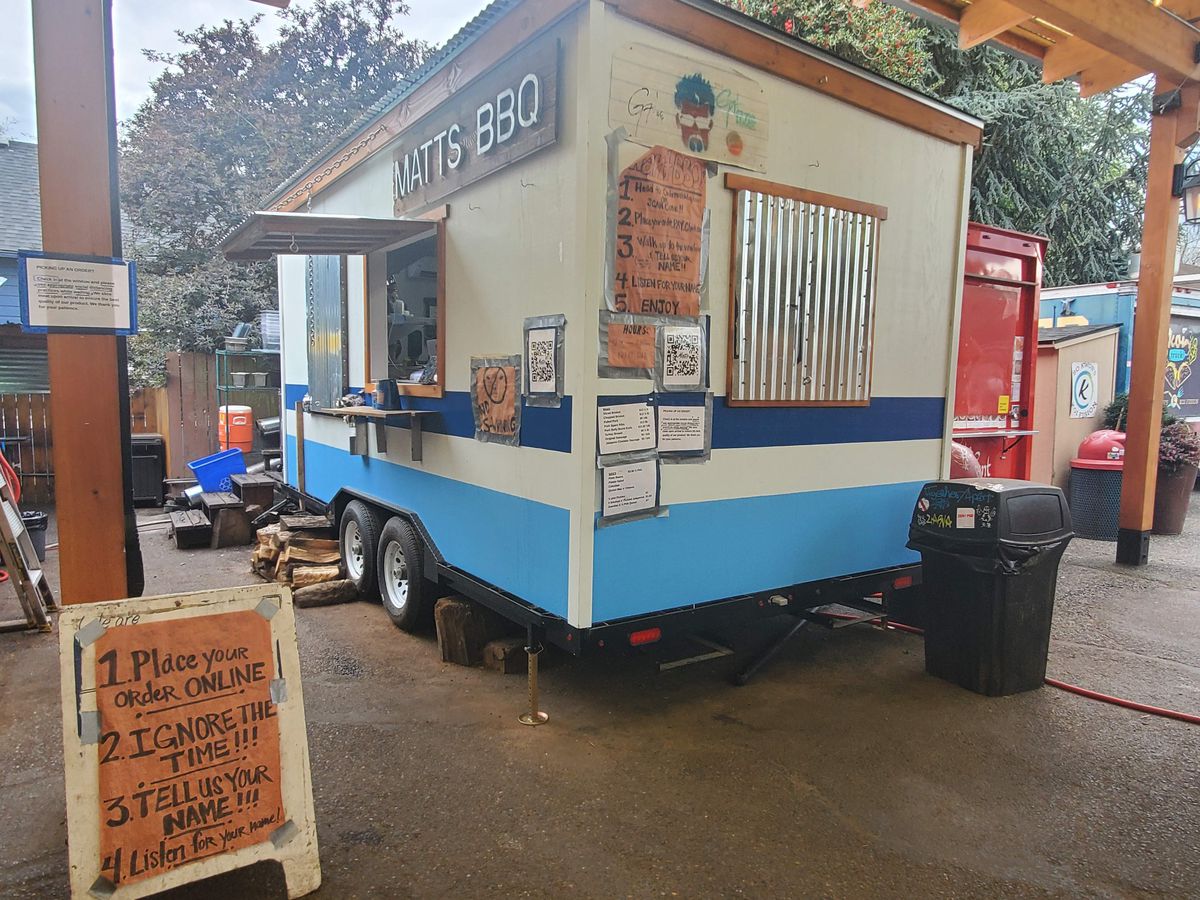 Matt’s blue and white food truck is seen, with signs showing how to order up front