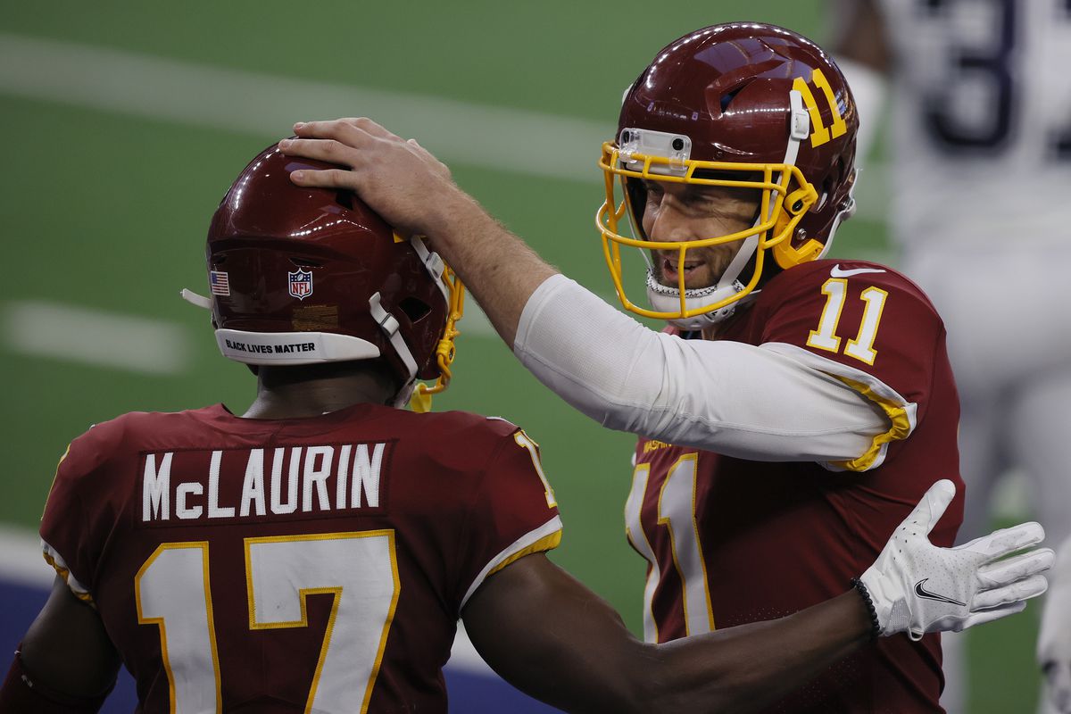 Alex Smith of the Washington Football Team celebrates with Terry McLaurin during the second quarter of a game against the Dallas Cowboys at AT&amp;T Stadium on November 26, 2020 in Arlington, Texas.