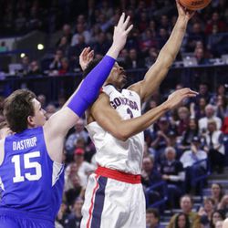 Gonzaga forward Johnathan Williams, right, shoots next to BYU forward Payton Dastrup (15) during the first half of an NCAA college basketball game in Spokane, Wash., Saturday, Feb. 3, 2018. (AP Photo/Young Kwak)
