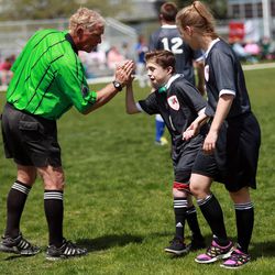 Alta's Chase Oredson gets a high-five from a referee during the 2014 Unified Soccer State High School Tournament, hosted by Special Olympics Utah and the Utah High School Activities Association, at Hillcrest High School in Midvale on Saturday, May 3, 2014.