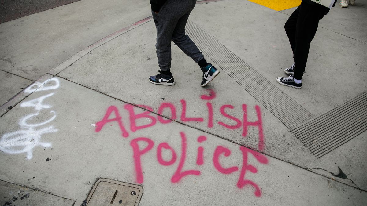 The spray-painted words “abolish police” on a Los Angeles sidewalk.