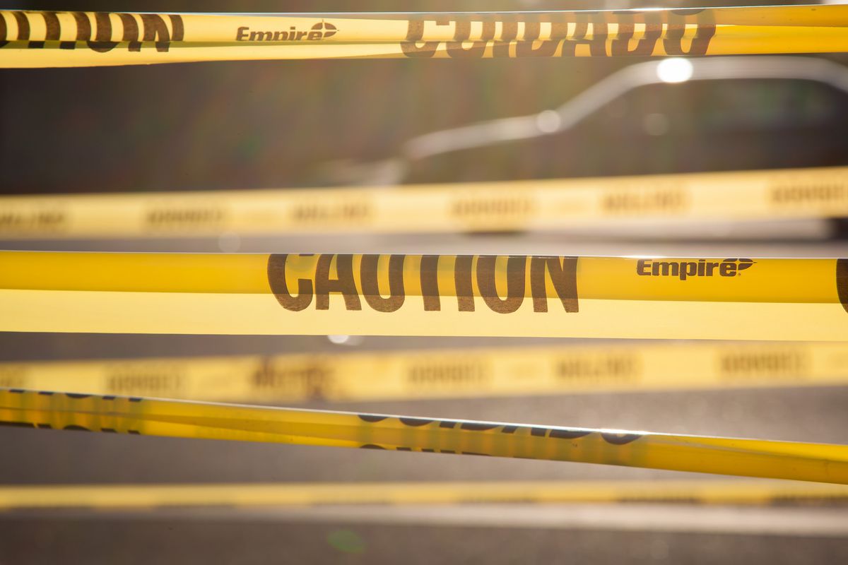 A cordon of yellow police tape wraps the frame of the image.