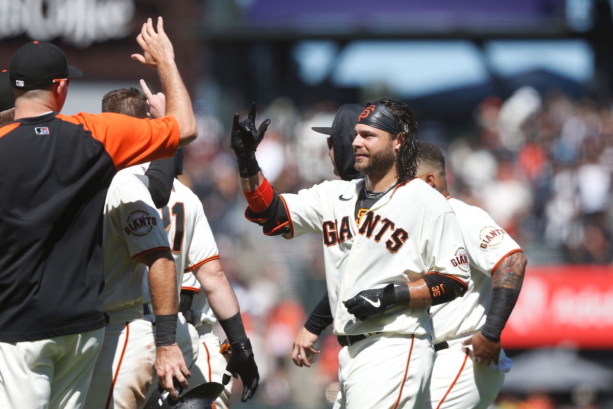 Brandon Crawford high-fiving teammates after a walk-off hit