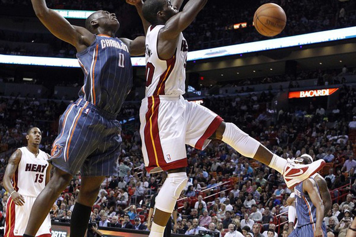 April 13, 2012; Miami, FL, USA;  Miami Heat center Joel Anthony (50) dunks the ball over Charlotte Bobcats center Bismack Biyombo (0) in the third period at the American Airlines Arena. Mandatory Credit: Robert Mayer-US PRESSWIRE