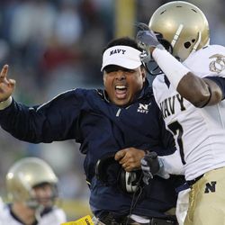 Navy head coach Ken Niumatalolo, left, reacts with safety Emmett Merchant following a turnover by Notre Dame during a game against Notre Dame in 2009. 