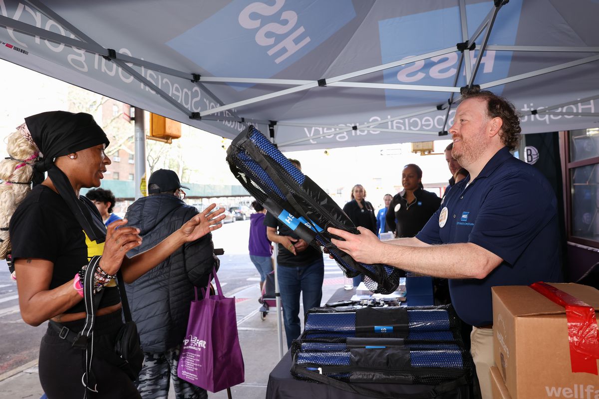 Yoga mat being handed out in East Harlem