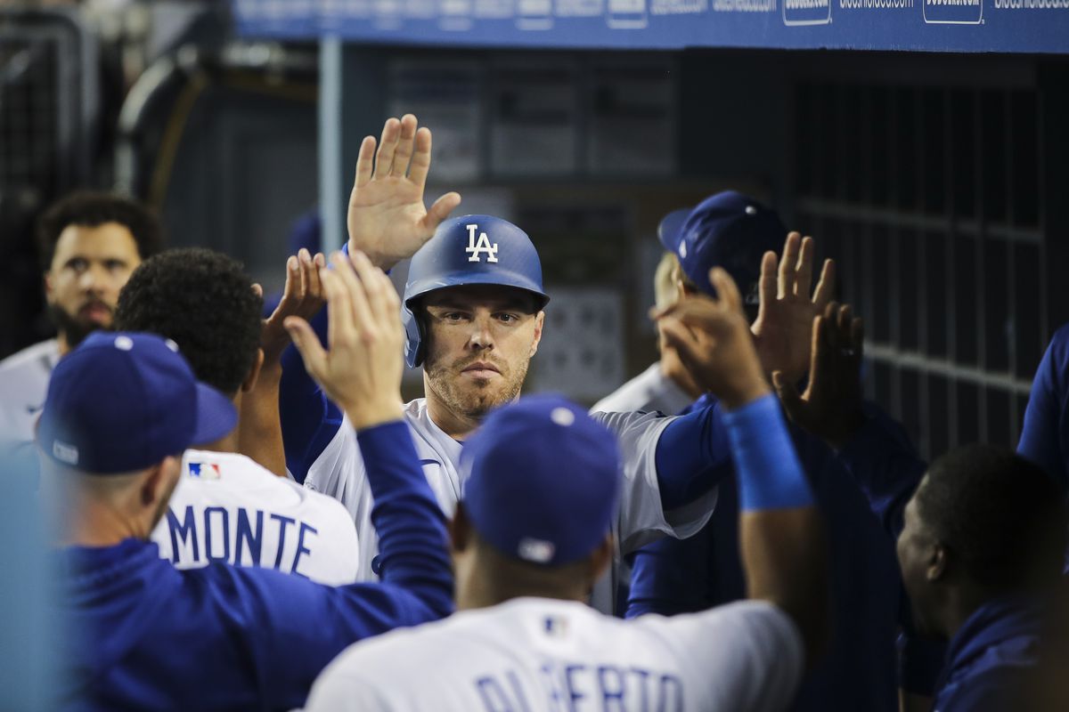 Freddie Freeman #5 of the Los Angeles Dodgers celebrates in the dugout after scoring a run in the eighth inning against the Philadelphia Phillies at Dodger Stadium on May 12, 2022 in Los Angeles, California.