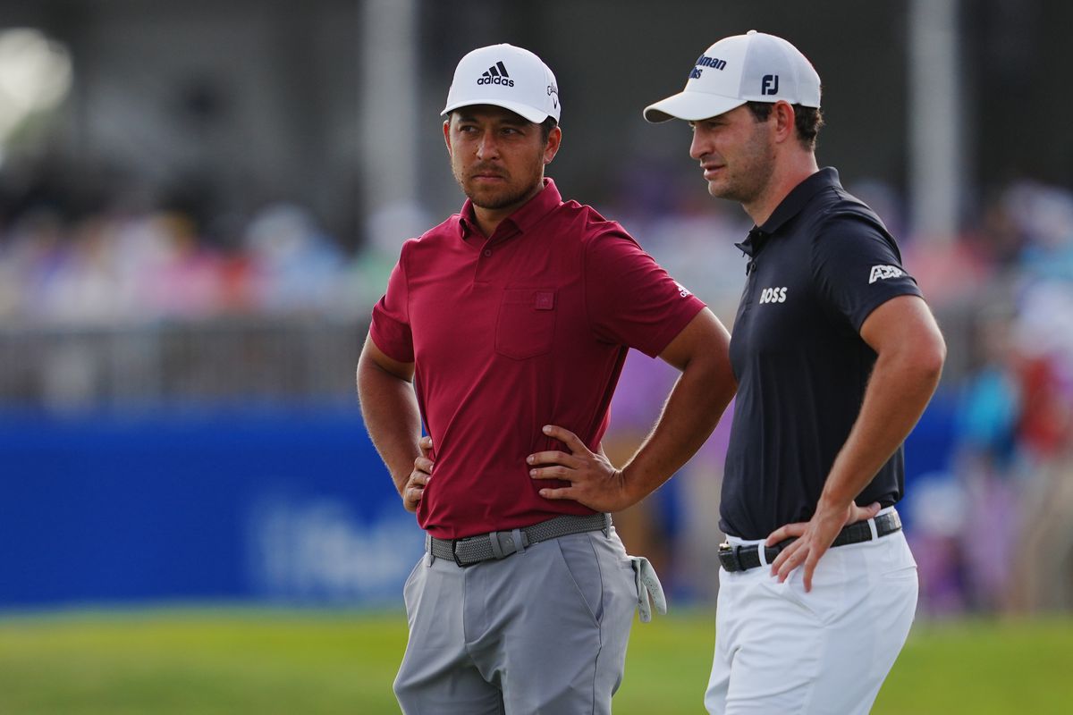 Xander Schauffele and Patrick Cantlay react after playing hole 18 during the third round of the Zurich Classic of New Orleans golf tournament.